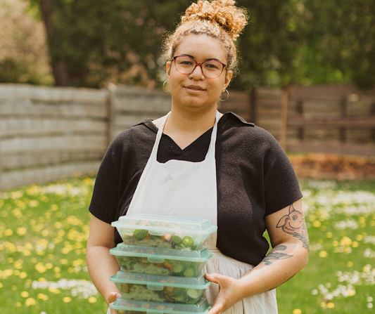 Celeste Lopreiato with a selection of vegan prepared meals