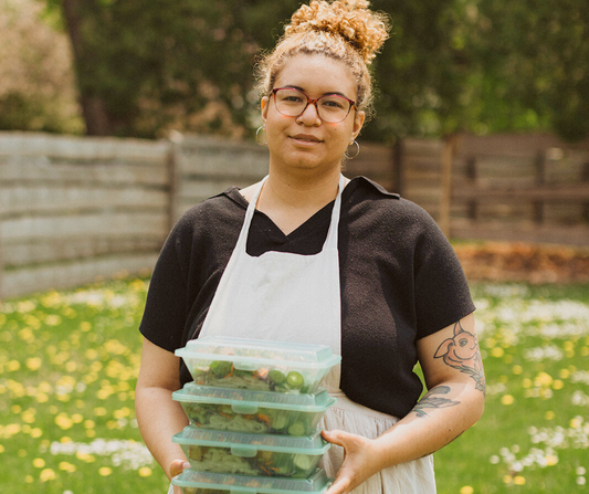 Celeste Lopreiato with a selection of vegan prepared meals 