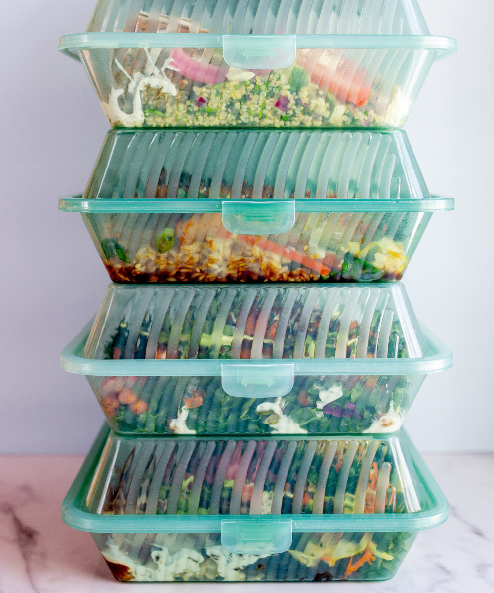 The Conscious Farm Kitchen prepared meals in reusable containers stacked on top of one and other.