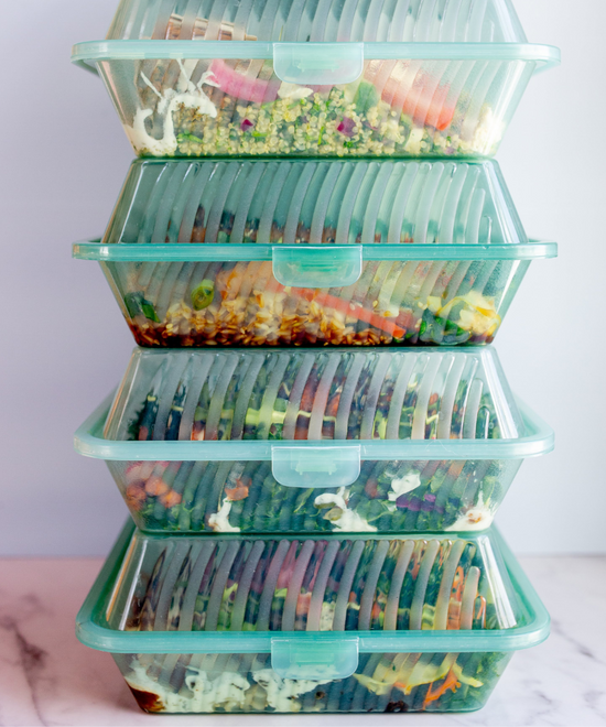 The Conscious Farm Kitchen prepared meals in reusable containers stacked on top of one and other.